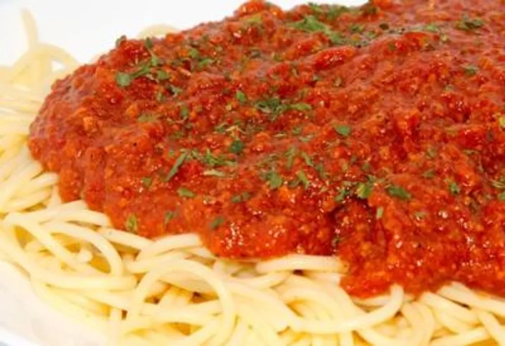 Spaghetti pasta covered in thick meat bolognese tomato sauce at Pizzeria 67, a Pizza Restaurant in Grand-Mère